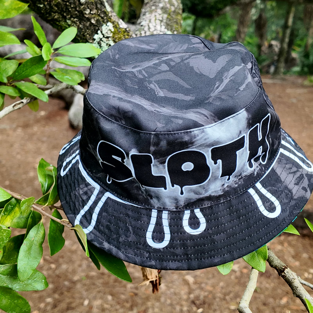 Drip side of the SLOTH reversible bucket hat seen from an angle, with white drip shapes around the brim