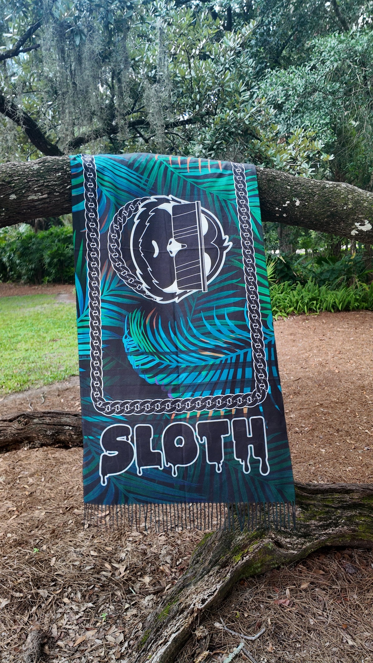 SLOTH Jungle Pashmina hanging over a mossy oak branch, seen from below
